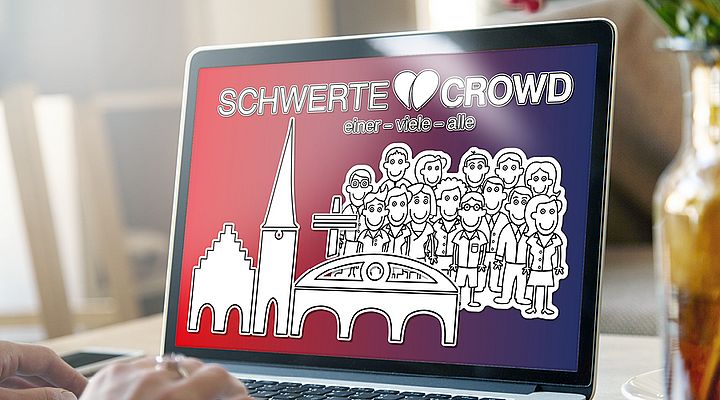 Unsere Schwerte Crowd Auf dem Display von einem Laptop sieht man das Logo der Schwerte Crowd.